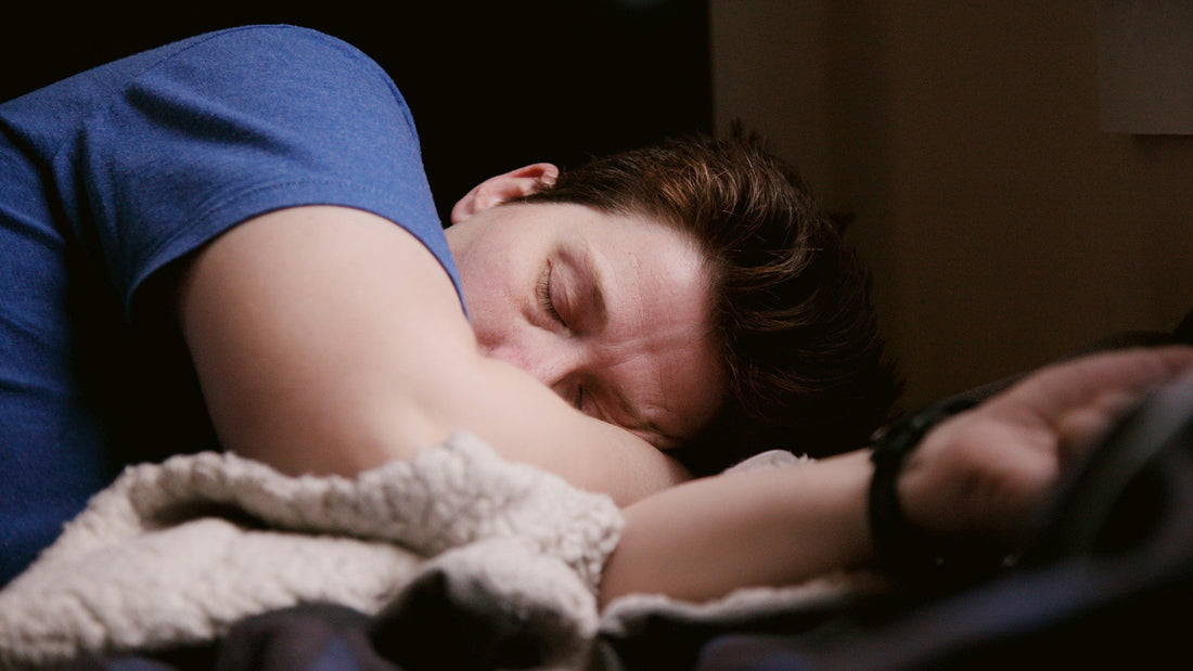 A man sleeping among blankets