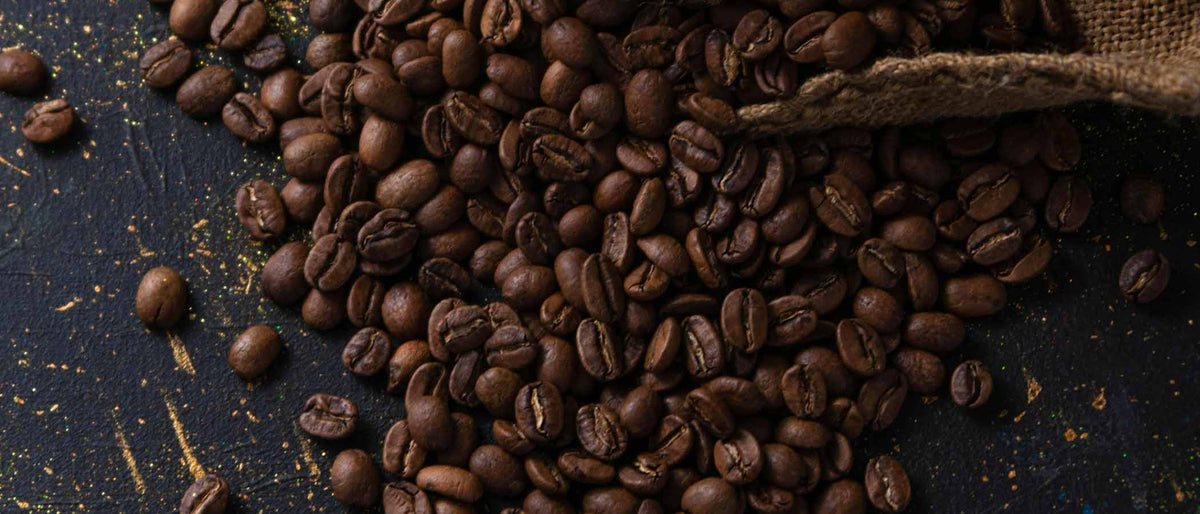 brown coffee beans scattered on a surface