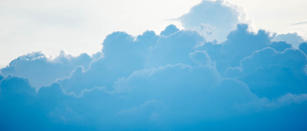 blue clouds under a white sky